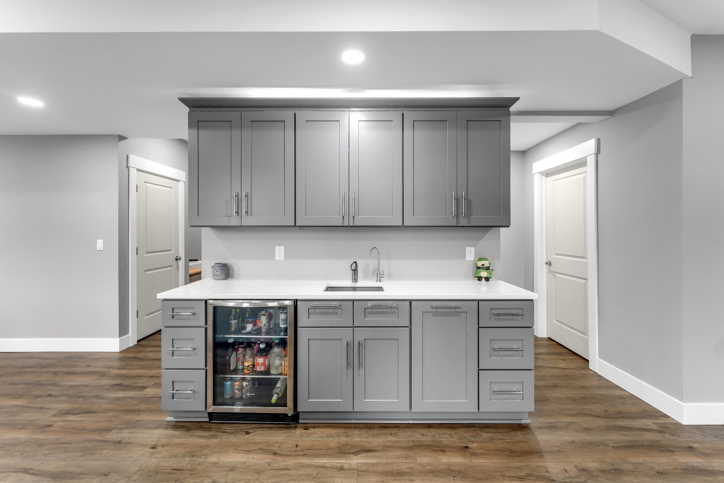 Luxury basement bar — dark cabinetry, quartz countertops