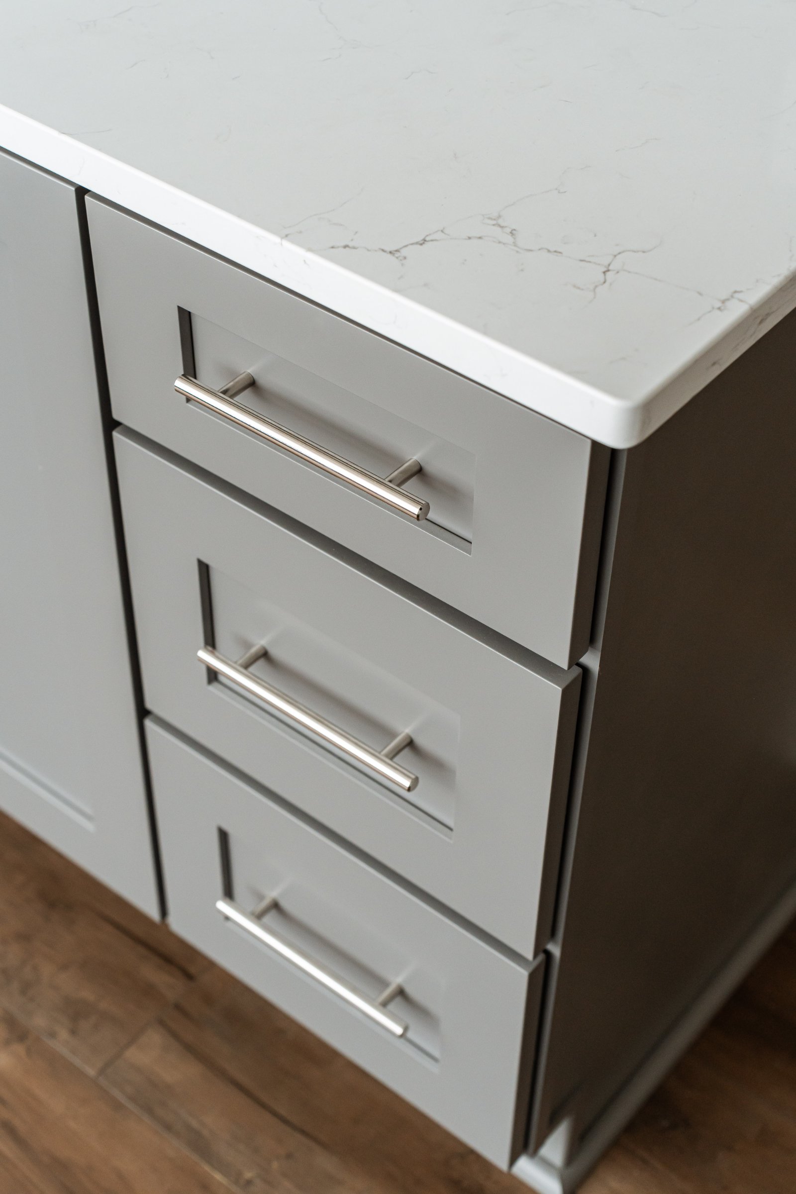 Finished luxury basement — open living area, pool table, bar, wood flooring