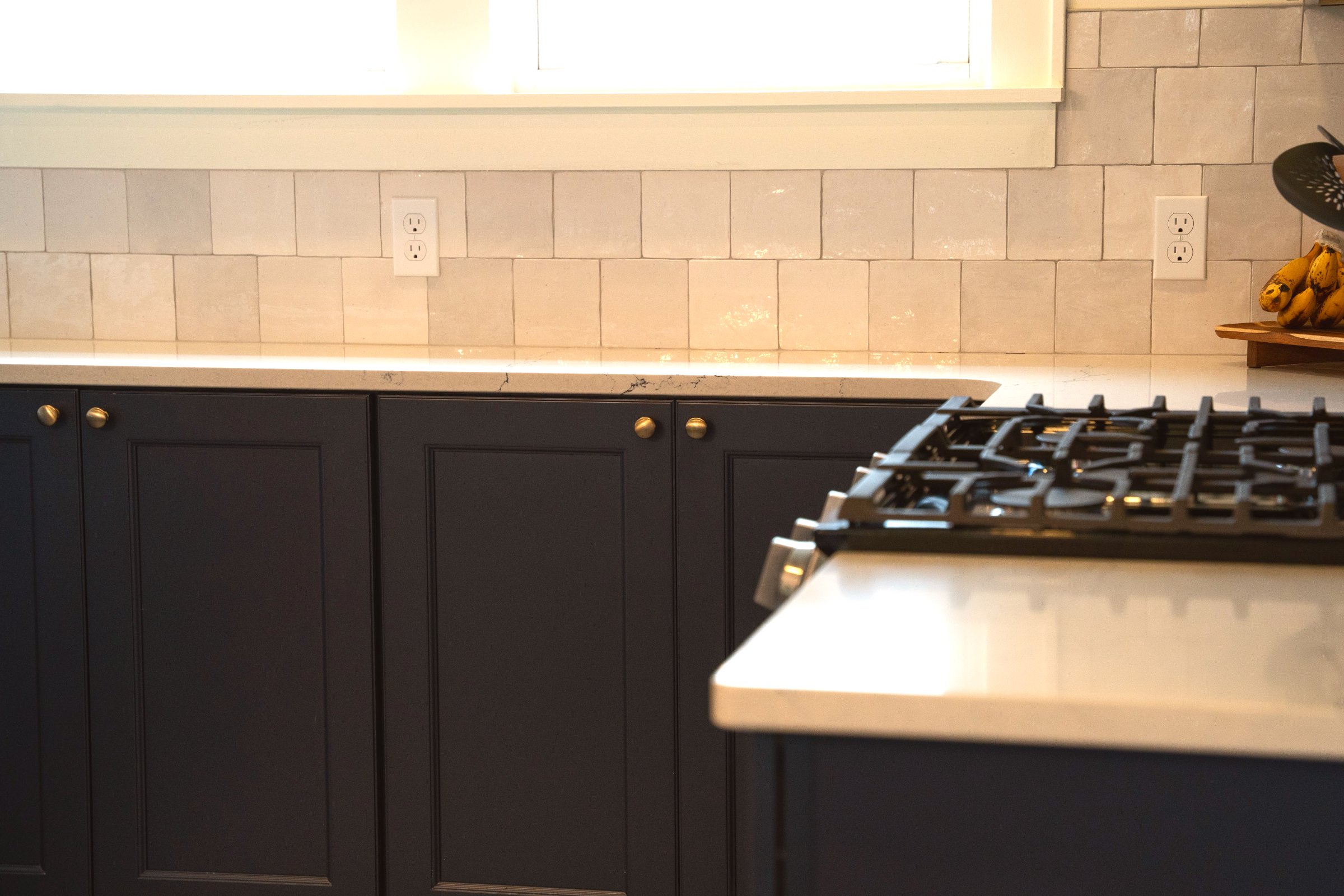 Kitchen remodel — navy blue cabinets, white quartz countertops, gold hardware