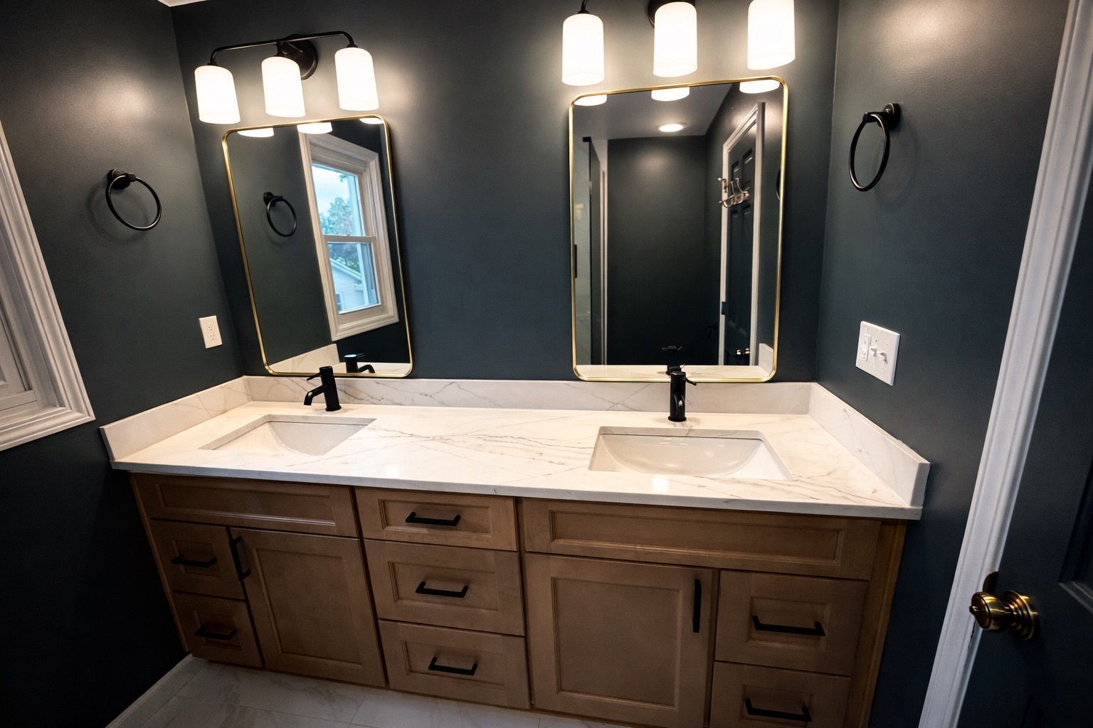 Bathroom remodel — moody blue-green walls, natural wood vanity, matte black fixtures